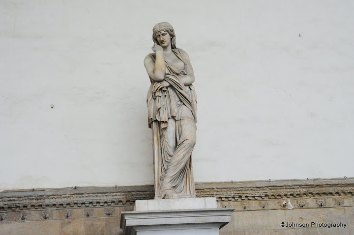 One of the five female marble statues on the back of the Loggia